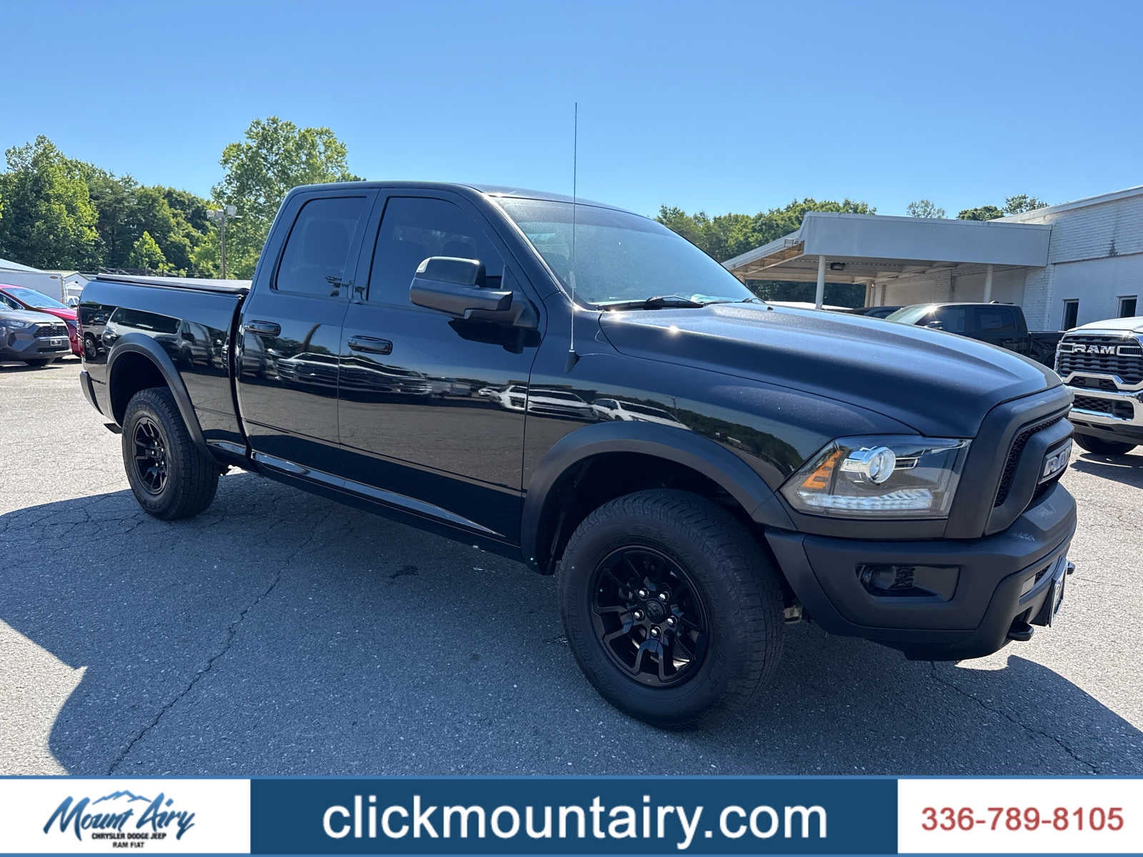 2021 RAM 1500 Classic Warlock Quad Cab 4x4 6'4' Box in Diamond Black Crystal Pearlcoat — front three-quarter view