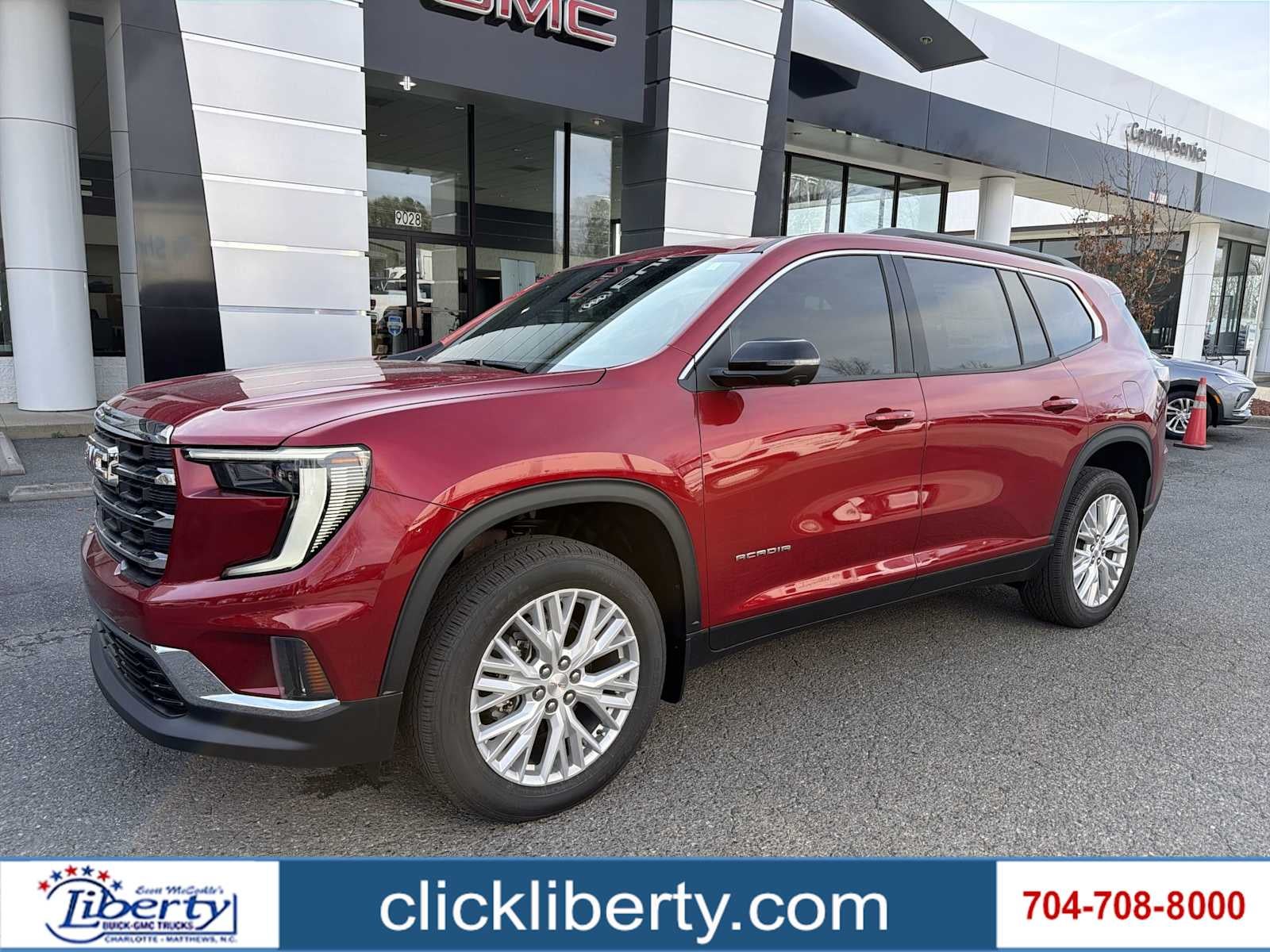 2026 GMC Acadia Elevation in Volcanic Red Tintcoat — front three-quarter view
