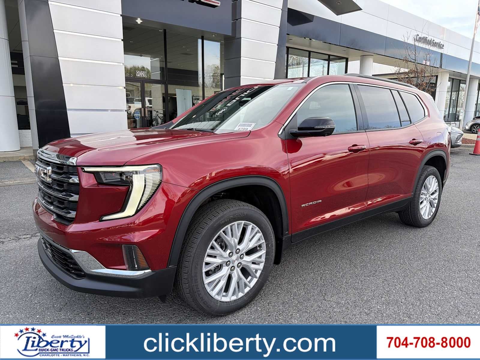 2026 GMC Acadia Elevation in Volcanic Red Tintcoat — front three-quarter view