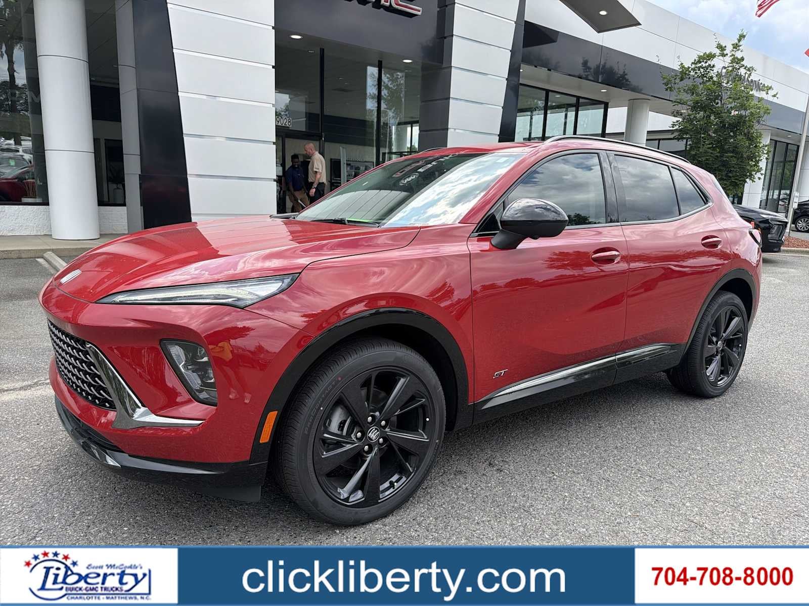 2026 Buick Envision Sport Touring in Brilliant Red — front three-quarter view